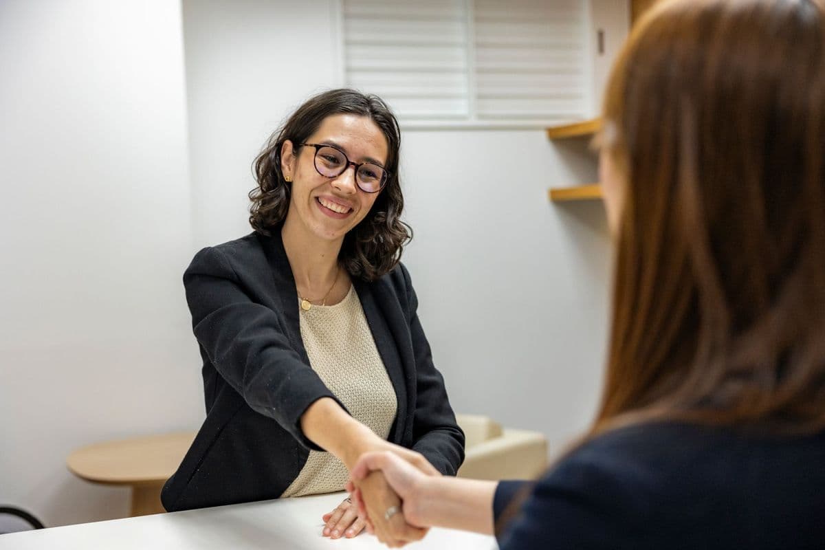 A candidate shaking hands with a recruiter after a job interview
